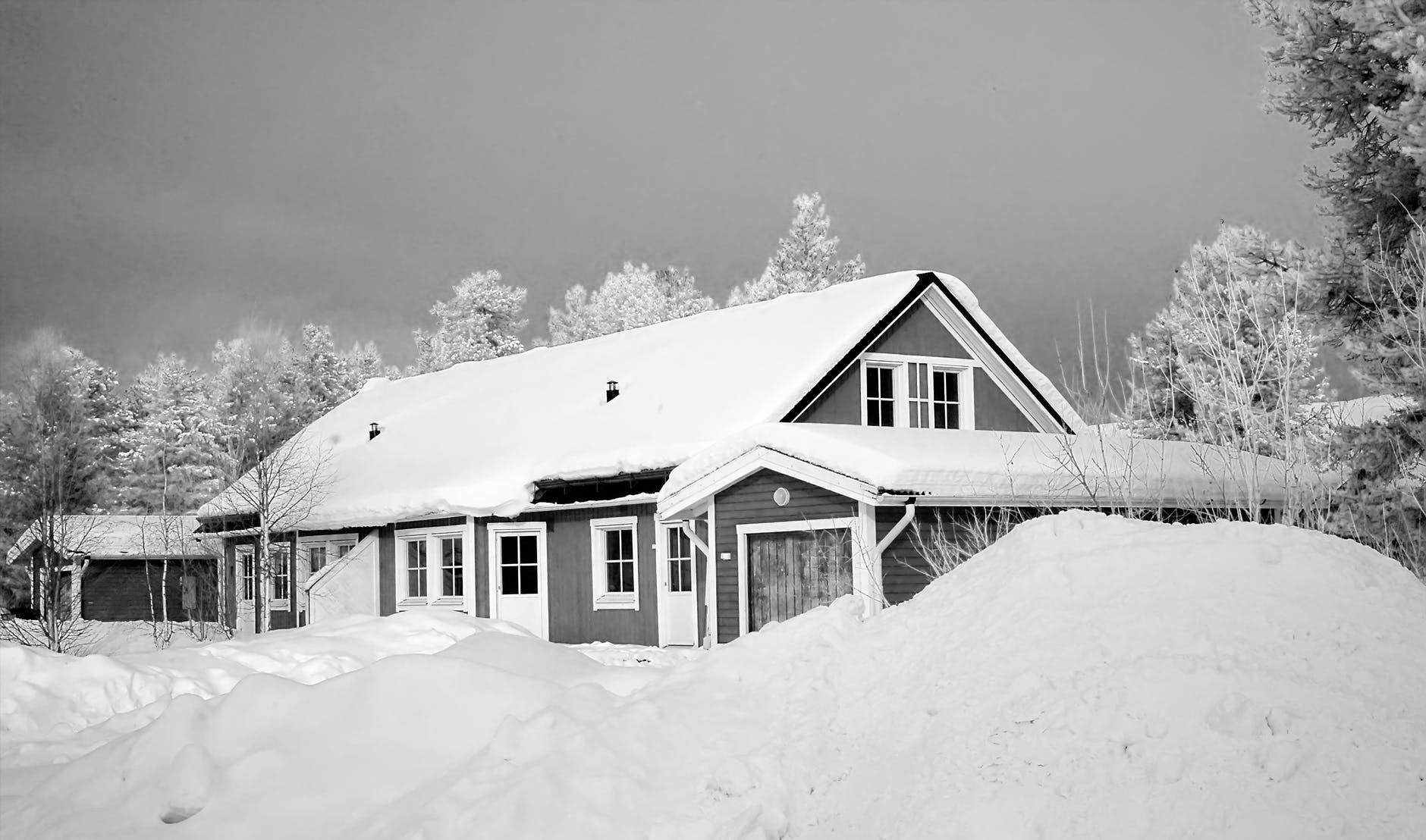 monochrome photography of snow capped house